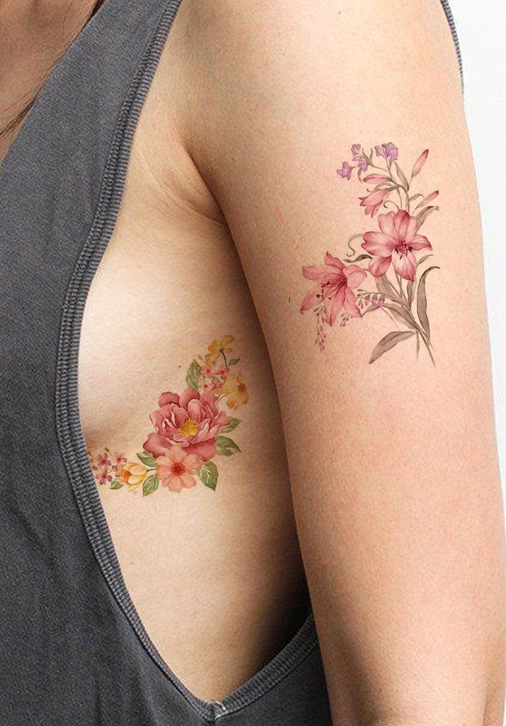 5 Flower Rib Tattoo Ideas for Women and Men 5 Watercolor floral tattoos on a person's ribcage and upper arm with soft pink petals.