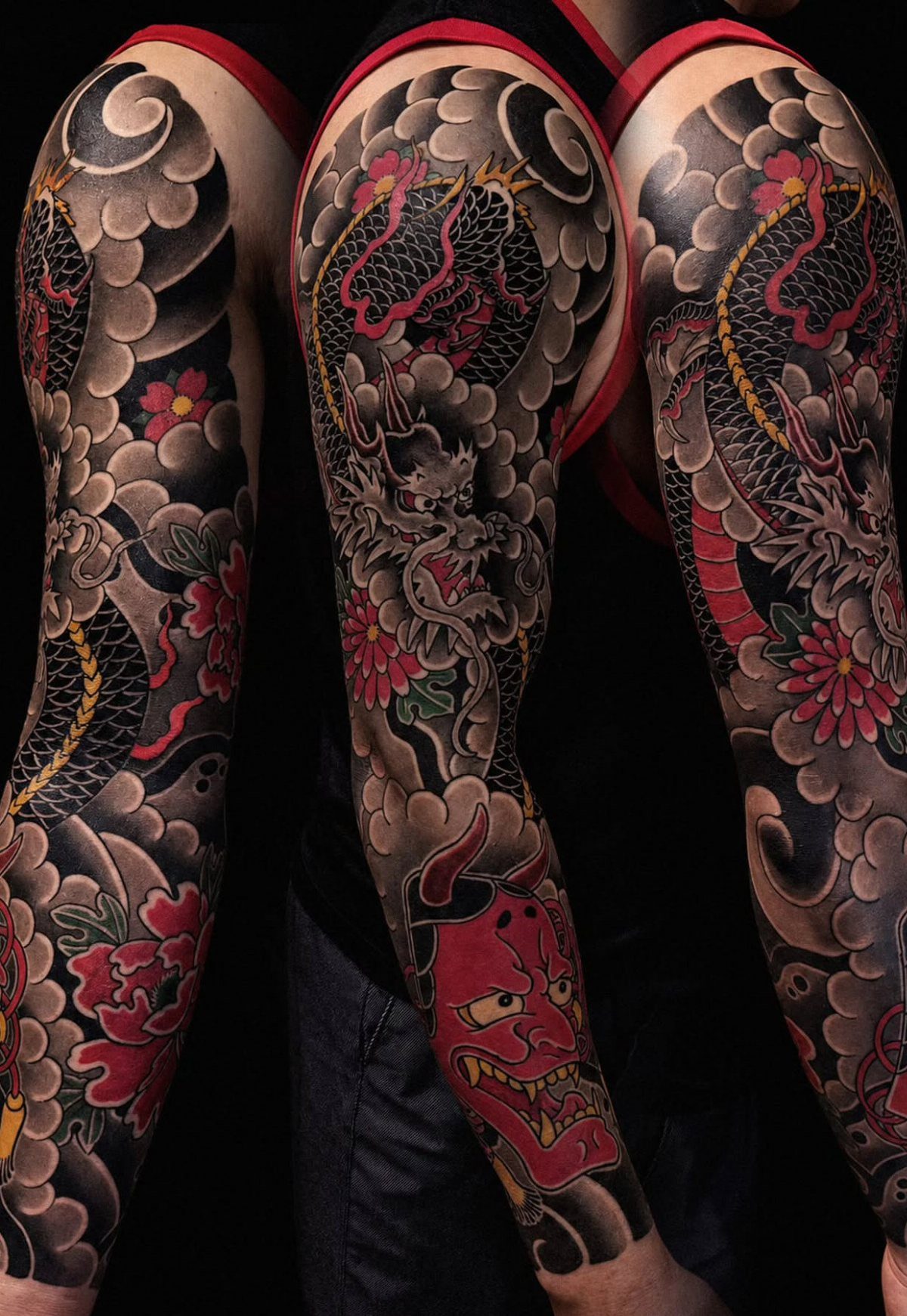 Japanese Dragon Tattoos: 19 Designs With Meaning and Style 18 Detailed Japanese dragon tattoos covering a person's arms with red flowers and a demon mask.