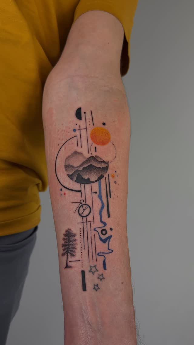 10 Mountain Landscape Tattoo Ideas For Your Next Ink 2 A geometric mountain landscape tattoo on a person's forearm with orange and black ink.