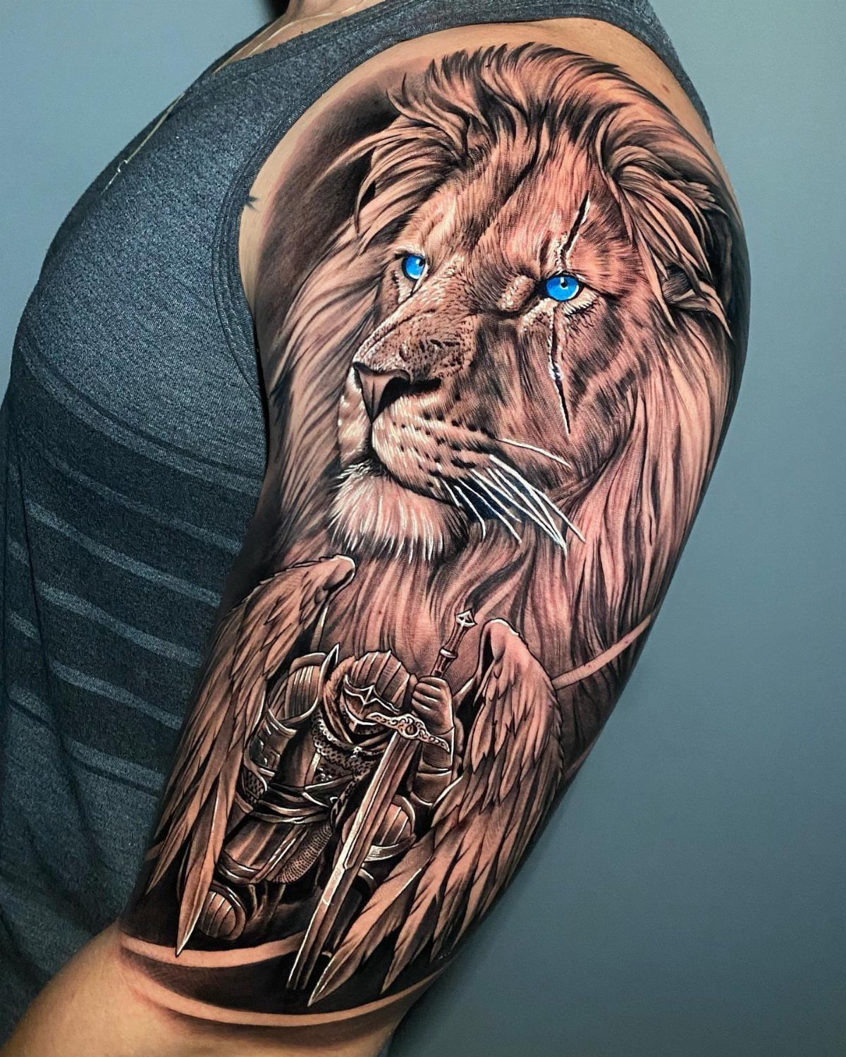 Sickness Tattoo Ideas: 6 Designs That Mean Something 1 A detailed lion and winged knight tattoo covering a person's shoulder and upper arm.