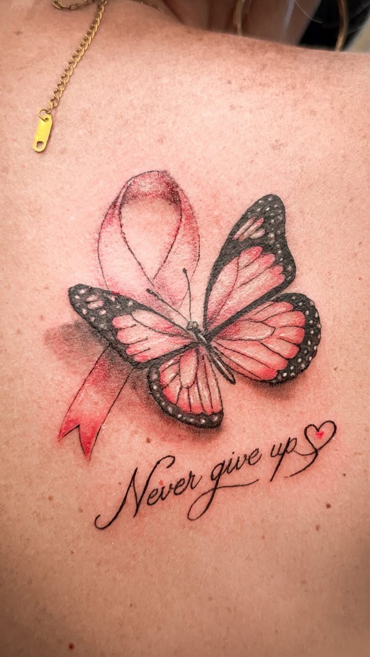 Sickness Tattoo Ideas: 6 Designs That Mean Something 3 A pink ribbon and butterfly tattoo with the text Never give up on skin.