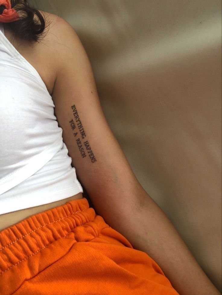 16 Word Tattoo Placement Ideas: From Spine to Finger 8 A vertical text tattoo on a person's inner bicep reading everything happens for a reason.