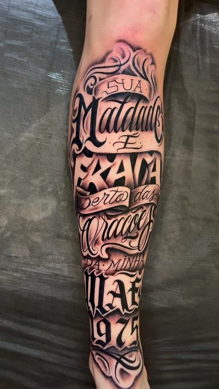 Black and grey Chicano style script lettering tattoo on a person's lower leg.