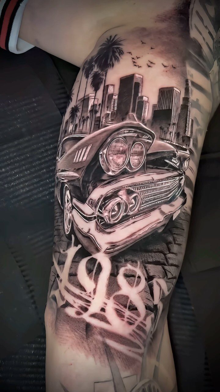 A detailed black and grey tattoo of a classic lowrider car against a city skyline.