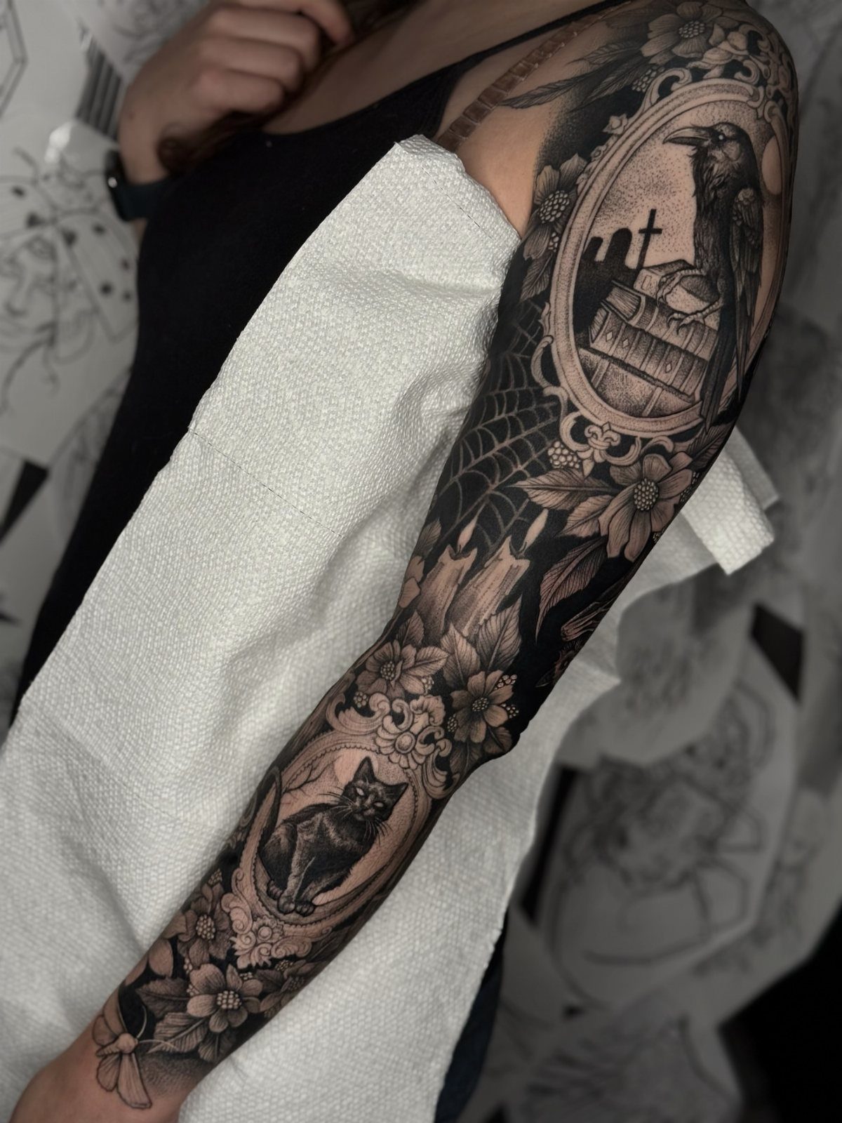 Tattoo Style Victorian: 5 Ideas From Acanthus Scrolls to Portraits 2 A detailed black and grey gothic Victorian sleeve tattoo on a person's arm.