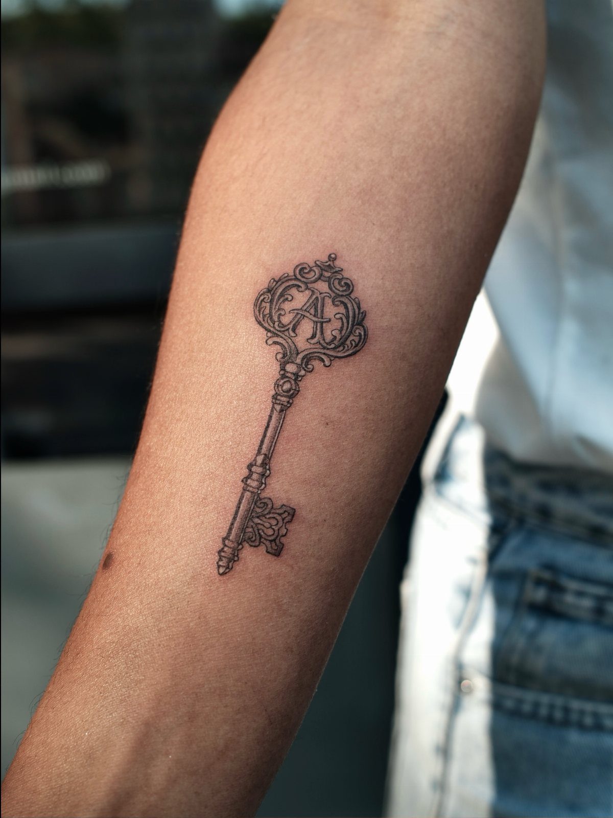 Tattoo Style Victorian: 5 Ideas From Acanthus Scrolls to Portraits 4 An ornate antique key tattoo with intricate scrollwork and the letter A on a forearm.